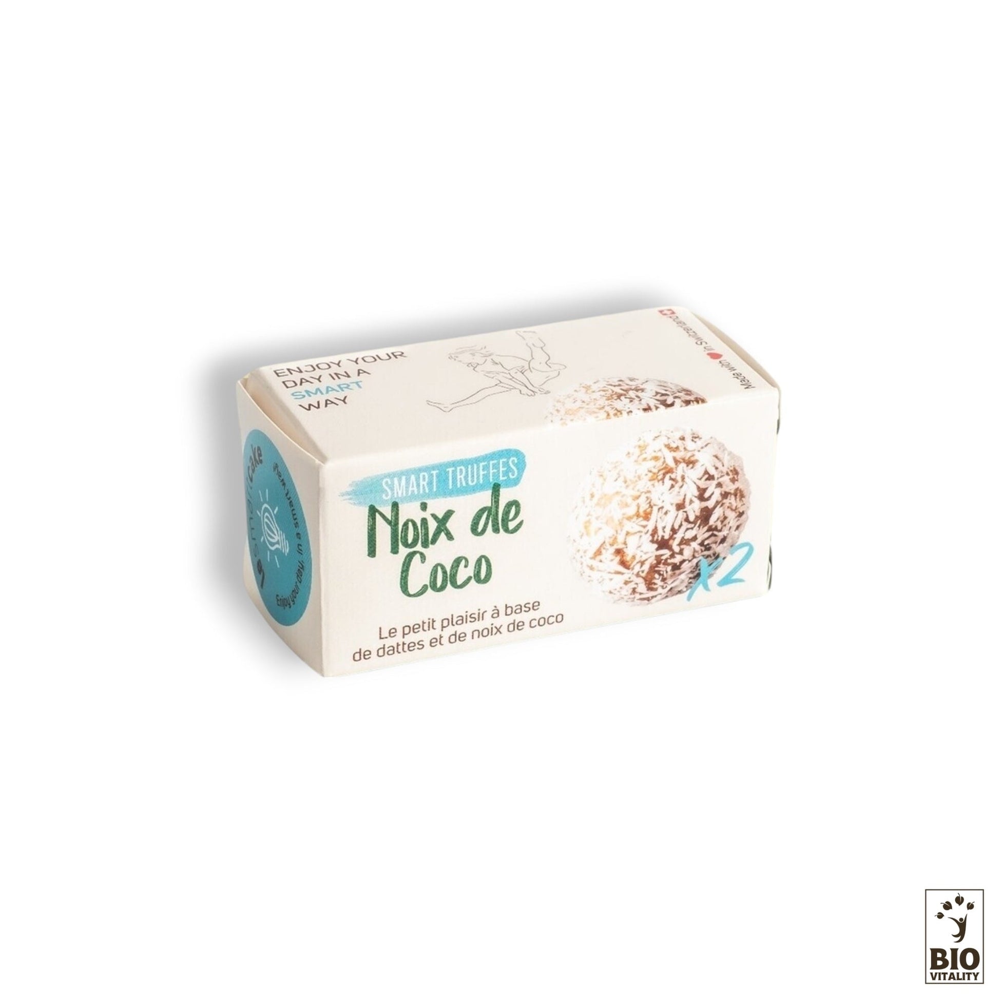 Le coffret est une petite boîte rectangulaire de Smart Truffes Noix de Coco - 2 pièces de LE SMART CAKE, ornée dun motif de noix de coco et étiquetée en français. Le logo Bio Vitality en bas à droite met en valeur ses ingrédients biologiques pour une essence naturelle.