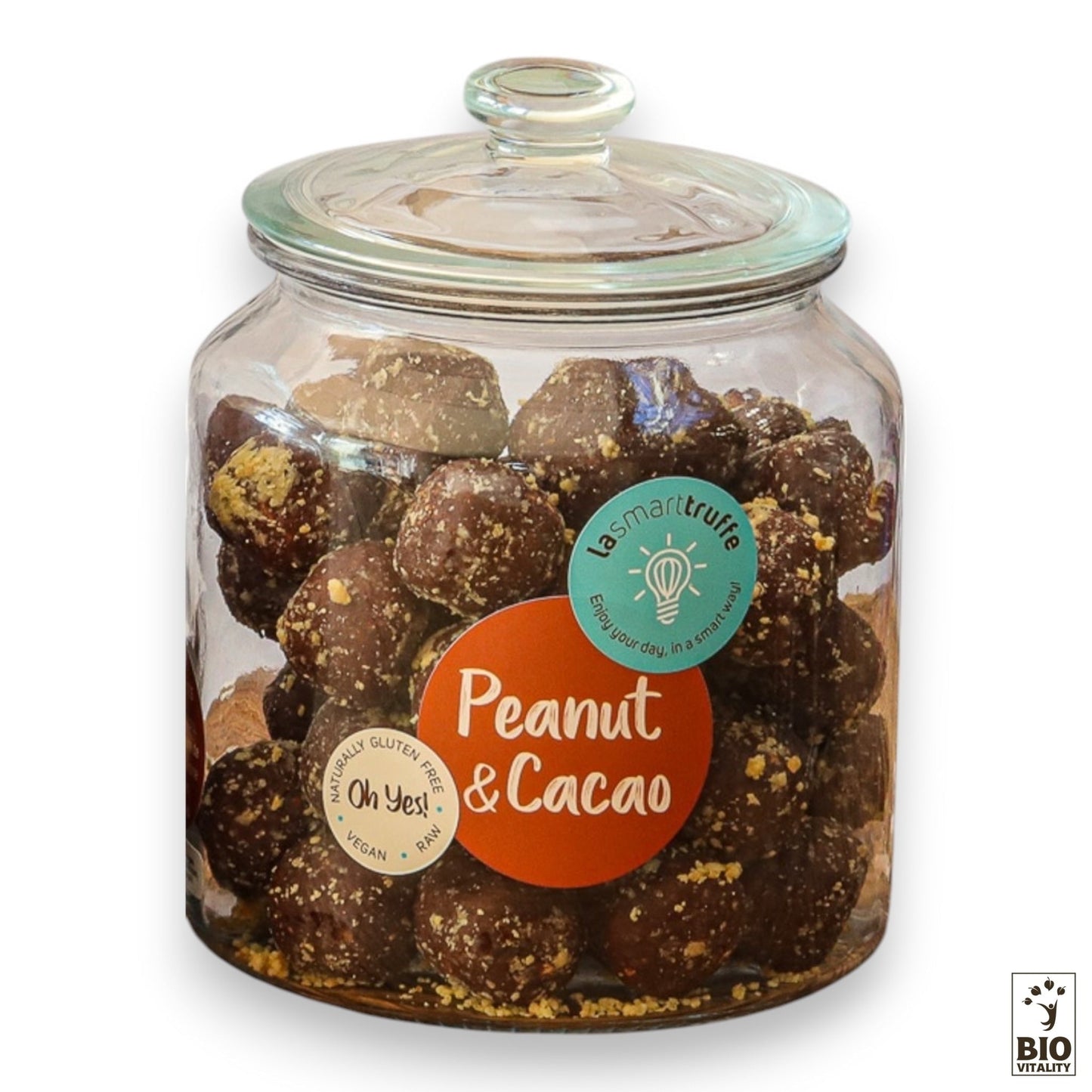 Un pot en verre de 500 g de Smart Truffes Cacao Cacahuète de LE SMART CAKE porte une étiquette indiquant quils sont sans gluten, végétaliens et crus. Le couvercle rond avec un bouton assure une conservation optimale des riches nutriments à lintérieur.