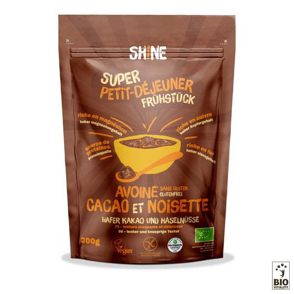 Lemballage brun de lAvoine Cacao cru et Noisette de SHINE (300 g) met en valeur les caractéristiques sans gluten, riches en fibres et végétaliennes. Il contient des flocons davoine pour une alimentation saine et est certifié BIO.