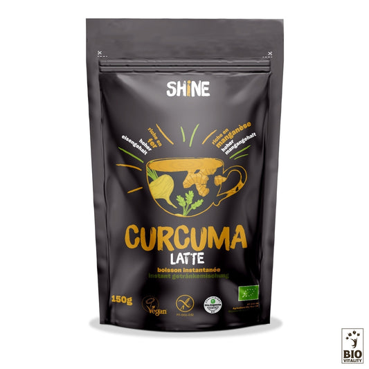 Un paquet noir de 150 g de Curcuma Latte Bio de SHINE, orné dillustrations de curcuma, de gingembre et de cannelle, met en valeur ses certifications végétaliennes et bio. Cette délicieuse boisson au curcuma offre de nombreux bienfaits nutritionnels.